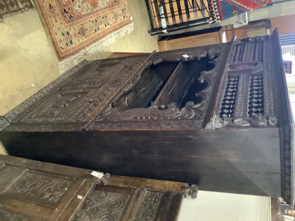 A late 19th century Flemish carved oak cabinet, width 145cm depth 48cm height 190cm